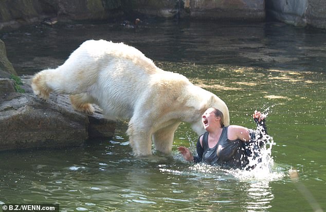 Incredible photos captured the bear pouncing on the woman and biting her neck, as the pain of the predator's bite was visible on her contorted face