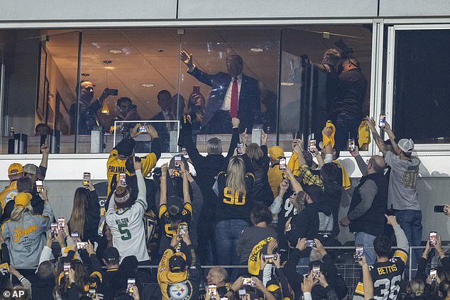 Donald Trump waves to the fans during the Pittsburgh Steelers - New York Jets game on Sunday