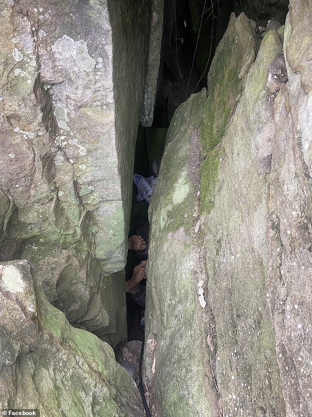 The woman became stuck upside down after slipping into a three-metre crevasse between two boulders