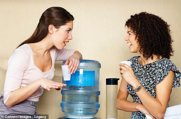 Huddled around the water cooler to share some workplace gossip is becoming an inevitable part of office life. A study has found that women justify gossiping by expressing concern about their target's well-being (file photo)