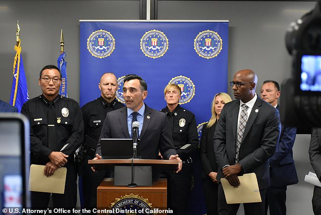 U.S. Attorney for the Central District of California Martin Estrada, center, announced charges against the Peckerwoods Gang on Wednesday, ranging from racketeering, firearms trafficking, drug trafficking and financial fraud