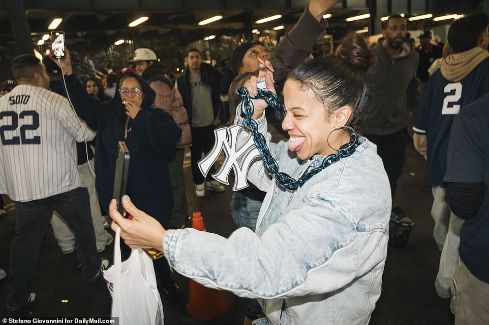 Yankees fans celebrate outside the stadium Tuesday night after the team earned its first World Series victory in 15 years