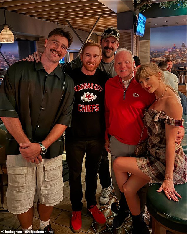 The loved-up couple posed for a photo with comedian Andrew Santino (second from left)