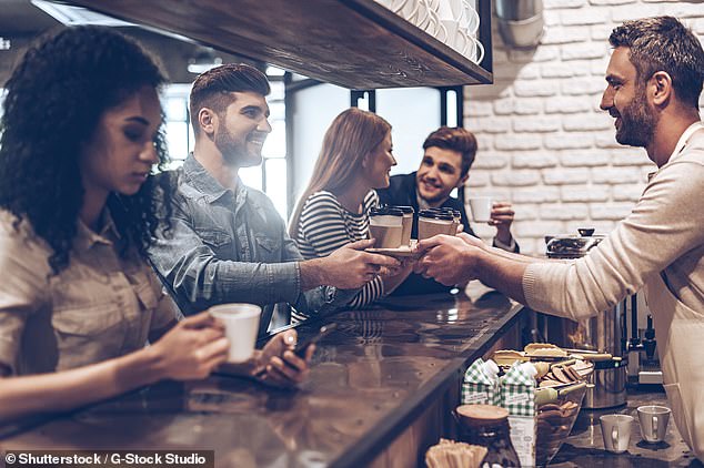 A barista served coffee to four coffee shop customers (stock image)