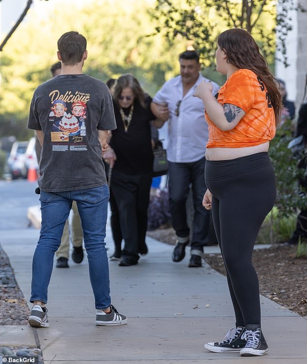 Ozzy Osbourne appeared weak as he was assisted by an assistant on his way to an autograph session in Hollywood on Saturday