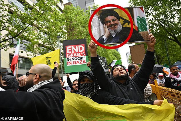 A protester holds up a photo of slain Hezbollah Secretary General Hassan Nasrallah during a pro-Palestine rally in Melbourne on Sunday