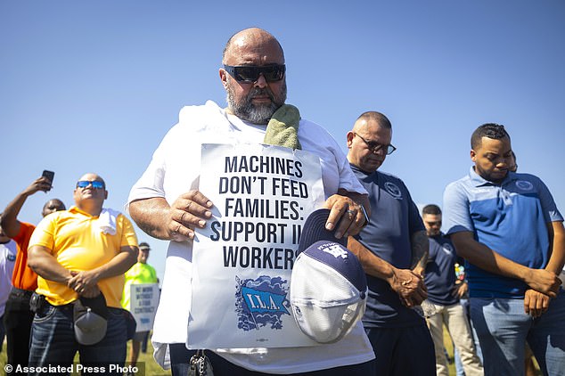 Dock workers bow in prayer during a strike at the Bayport Container Terminal