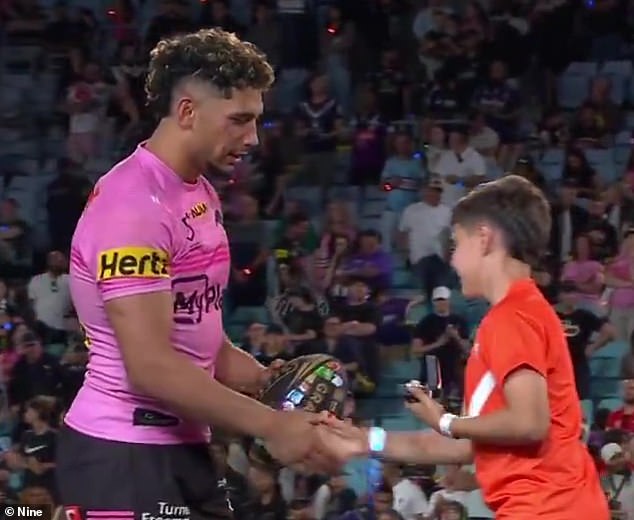 Tago walks onto the stage to collect his premiership ring after the Penrith Panthers' victory over the Melbourne Storm in the 2024 NRL Grand Final