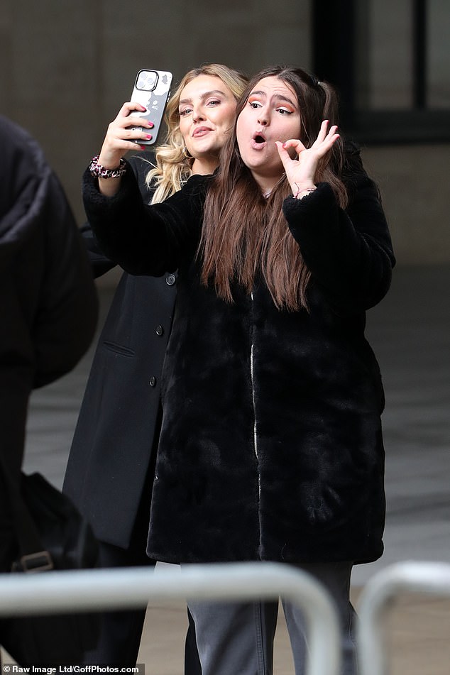 Perrie Edwards, 31, appeared to be having a good time as she posed with fans outside the BBC Broadcasting house on Thursday