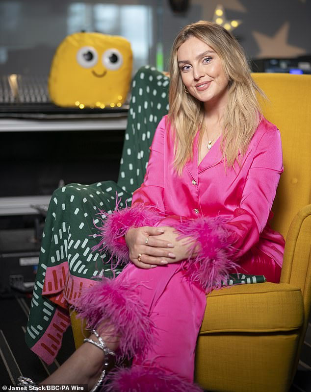 Perrie Edwards looked fantastic in a pretty pink satin pajama as she filmed the latest CBeebies Bedtime Story which airs on Friday