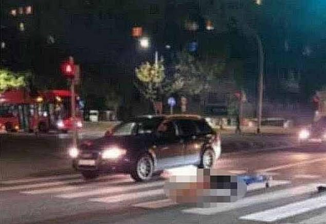 In the photo, the body lies on a white-striped zebra crossing, where it had fallen from the hearse