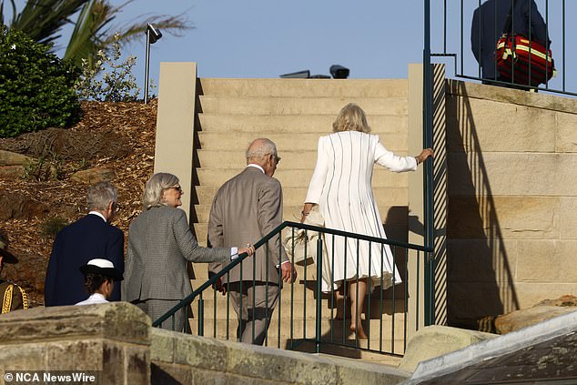 She was seen barefoot as she climbed the steps of the dock with one hand on the railing and the other holding her heels, bag and coat.