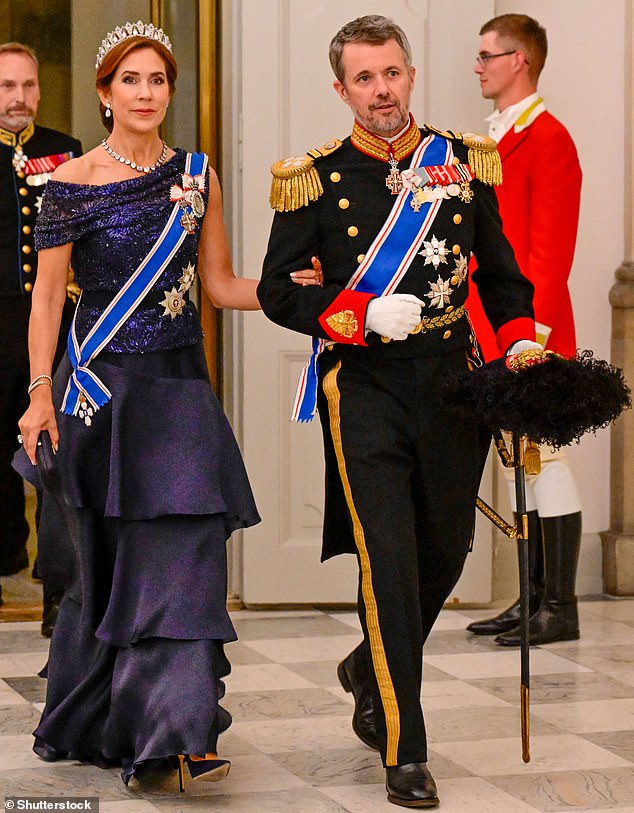 Queen Mary of Denmark (pictured, left) looked stunning in a deep blue dress as she attended a state banquet in Copenhagen with King Frederik (pictured, right) on Tuesday evening