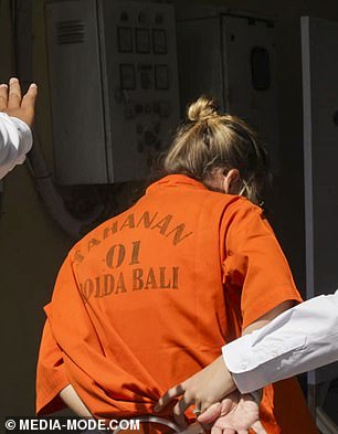 Lynley Le Grand was dressed in an orange prison shirt, which had the word 'Tahanan Polda Bali' on it, which means 'Detainee, Bali Police'.