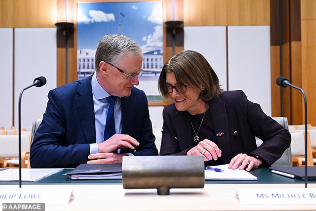 Australia's most powerful banker is paid $100,000 more than her male predecessor, new figures reveal (Michele Bullock is pictured right with former RBA governor Philip Lowe)