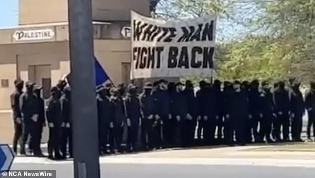 About 50 masked men were seen marching through Corowa, on the NSW-Victoria border, on Saturday, chanting white supremacist slogans