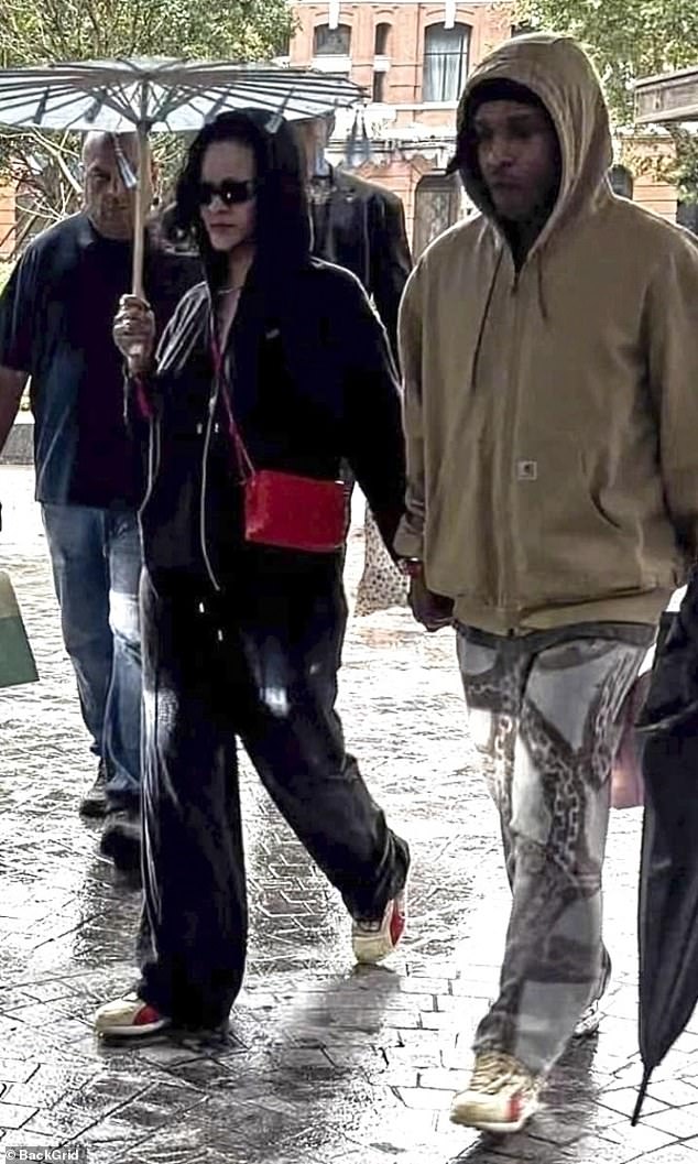 Rihanna and A$AP Rocky put on low-key displays as they battled the rain in Shanghai, China, on Tuesday