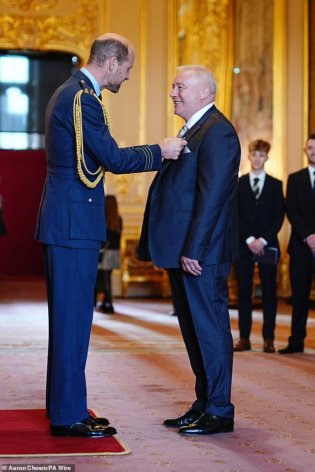 Prince William is pictured honoring Ally McCoist with an OBE for services to football and broadcasting at Windsor Castle on October 2