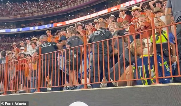 Terrifying footage has emerged from Saturday's epic Georgia-Texas game, showing a spectator being chased out of the crowd by emergency services in Austin