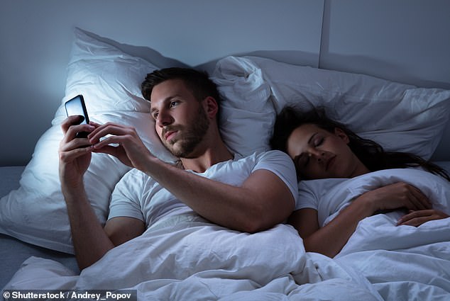 Researchers have found another reason to avoid scrolling on your phone at night, as they reveal that your device may contain bacteria usually found in cockroach feces (stock image)