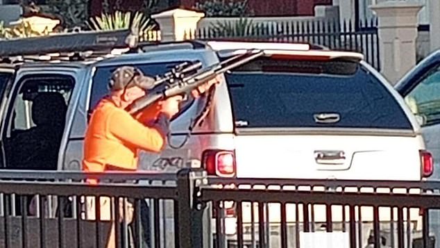 Residents in Adelaide's west got the shock of their lives when they saw a man with a gun and in hi-vis pull out a large handgun on their street (pictured)