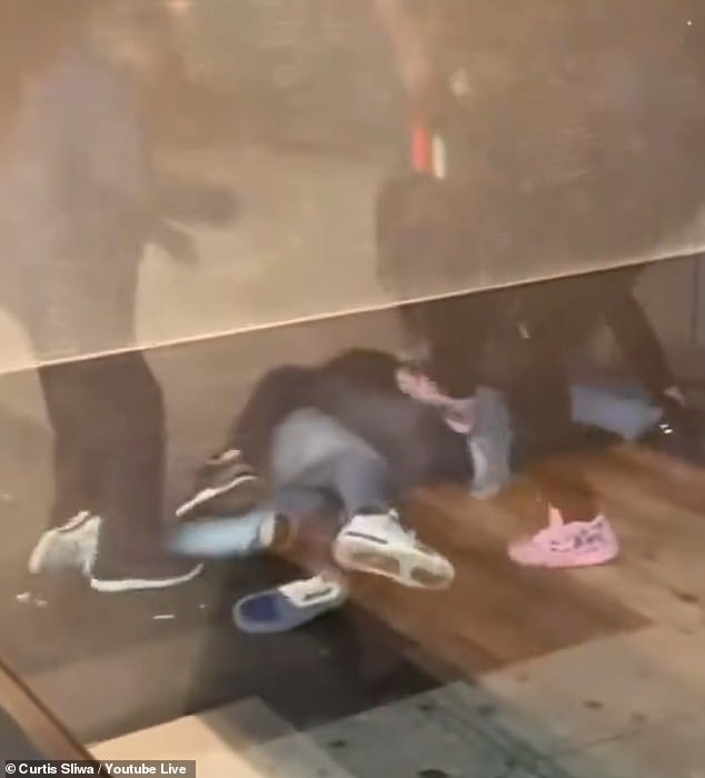 A restaurant filmed the kicks flying in as the 20-year-old lay helpless on the ground