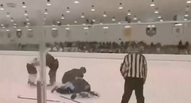 Shocking moment mass brawl breaks out on the ice: Hockey players held for 'hooliganism' and forced to hand over passports after violence erupts between teams in the rink