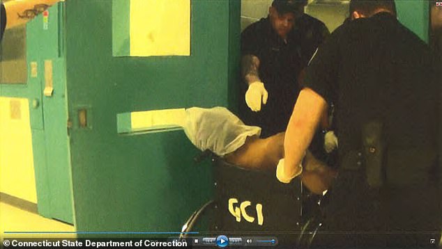 Corrections officers wheeled J'Allen Jones out of his cell after beating him