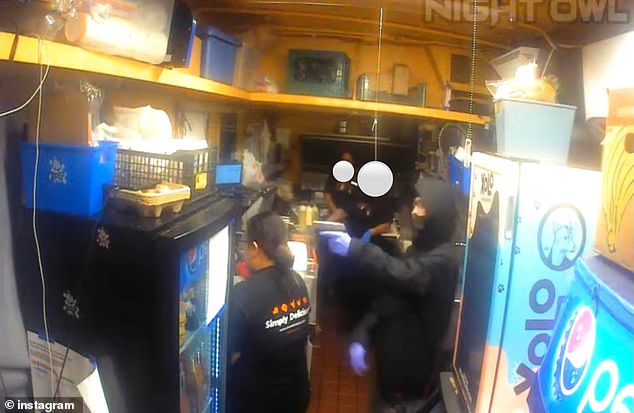 Surveillance video shows the suspect wearing a black hoodie, glasses and blue gloves pointing his gun at a woman's head as he forces her to empty the cash register at the Arden Way store on Oct. 28.