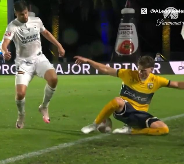 Mariners defender Lucas Mauragis (right) about to 'introduce' himself to Melbourne Victory coach Patrick Kisnorbo