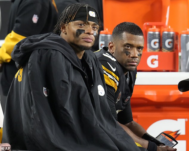 Pittsburgh Steelers quarterbacks Russell Wilson, right, and Justin Fields sit together