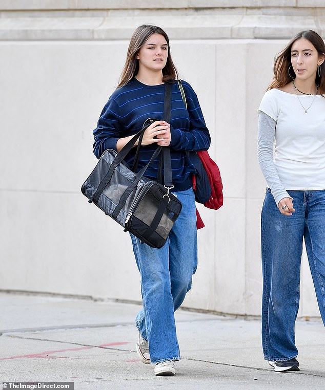 Suri Cruise stepped out in New York on Sunday with mom Katie Holmes' cat — amid her return to the city during her first semester at Carnegie Mellon