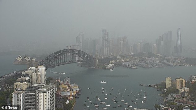 The Sydney Harbor Bridge and Opera House were shrouded in clouds and mist on Monday