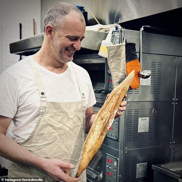 A popular bakery has been defaced with shocking anti-Semitic graffiti, with a threatening note reading 'be careful' - but owner Ed Halmagyi (pictured) defiantly left the graffiti there