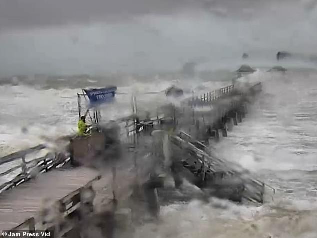 A man braved Hurricane Milton on Wednesday and planted a Trump 2024 flag on a pier in Naples, Florida, as high winds and waves battered the dock