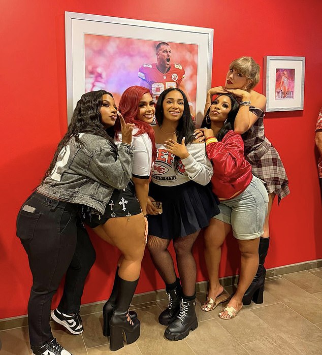 Taylor Swift posed next to a photo of Travis Kelce with her fellow Kansas City Chiefs WAGs