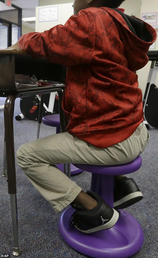 The 7-year-old boy was allegedly beaten after standing on a 'wobble chair' (pictured) - a stool that doubles as a sensory device for students