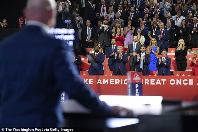 Former President Donald Trump looks on as Sean O'Brien, president of the International Brotherhood of Teamsters, speaks at the RNC in July