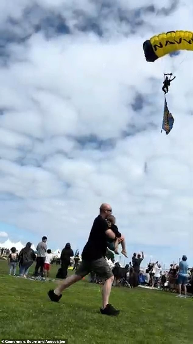 A clip from Mia's video of the incident shows the paratrooper heading for disaster outside the target. A father appears to be running to the side while carrying his child