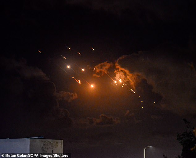 Ballistic missiles are pictured in the skies over Israel after being launched by Iran last night