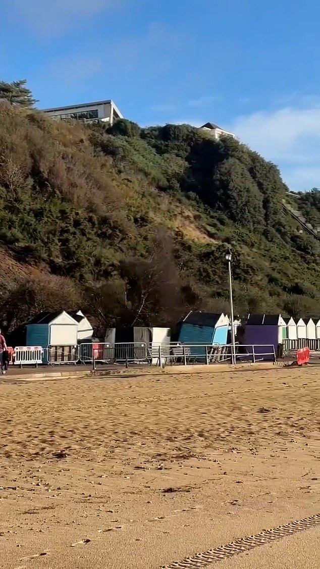 The man narrowly misses the huge landslide off a cliff in Bournemouth