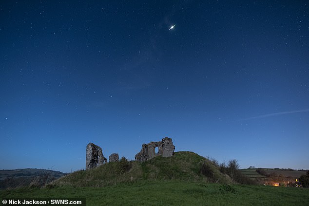 Stargazers will be in for a treat tonight as the spectacular Orionid Meteor Shower reaches peak activity from midnight. Pictured: The Orionid meteor shower over Clun Castle, Shropshire