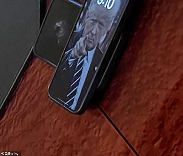 When zoomed in, it becomes clear that the lock screen image is Trump from July 19, 2019, when he was still in office