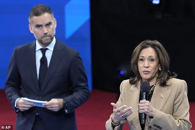 Kamala Harris speaks to undecided Hispanic voters during Univision's town hall. The event was moderated by Enrique Acevedo (left)