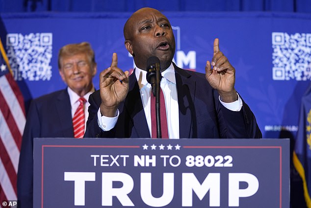 Republican presidential candidate, former President Donald Trump, left, listens as Sen. Tim Scott, R-S.C., speaks during a campaign event in Concord, New Hampshire