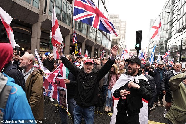 Far-right protesters walk through London on Saturday at a rally backed by Robinson