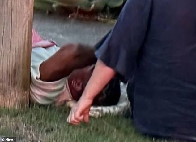 Mom was reportedly behind the wheel of a ute that crashed into an Uber in the Brisbane suburb of Bardon on Friday (Mum is pictured on the ground moments after the collision)