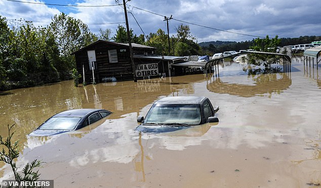 Cars are submerged in a flooded area at a used tire dealership after Tropical Storm Helene in Hendersonville, North Carolina, USA, September 27