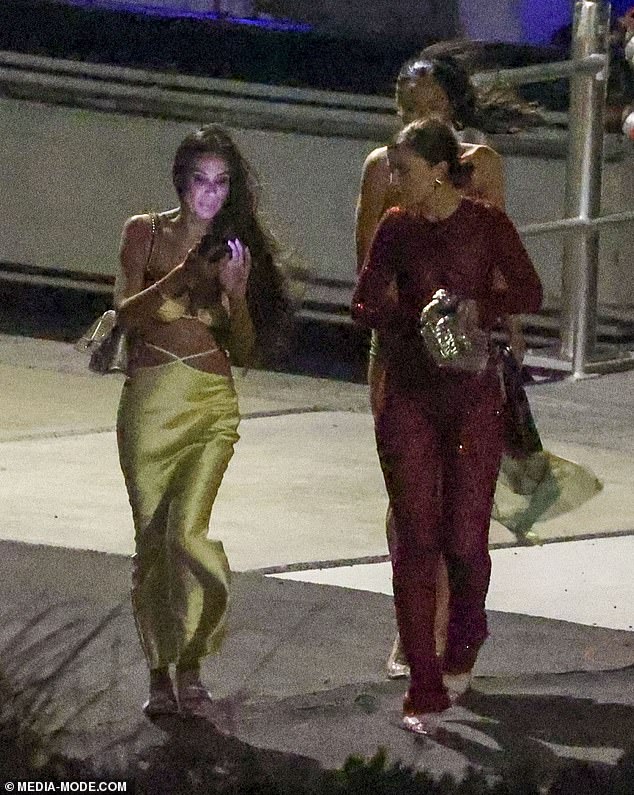 Another guest stunned in a daring red catsuit (right), while yet another turned heads in a gold number with criss-cross detailing at the waist and a low-cut bust (left)