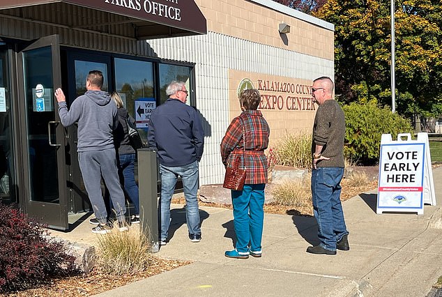 Voters wait in line for ballots cast in the 2024 election on the first day of early in-person voting in Michigan on Oct. 26